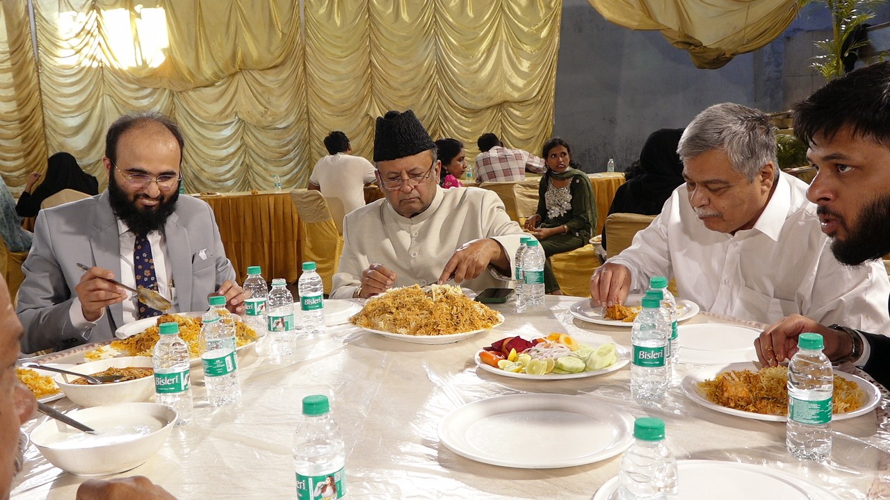 Guests at a round table with plates of biryani at the expo dinner, 2025